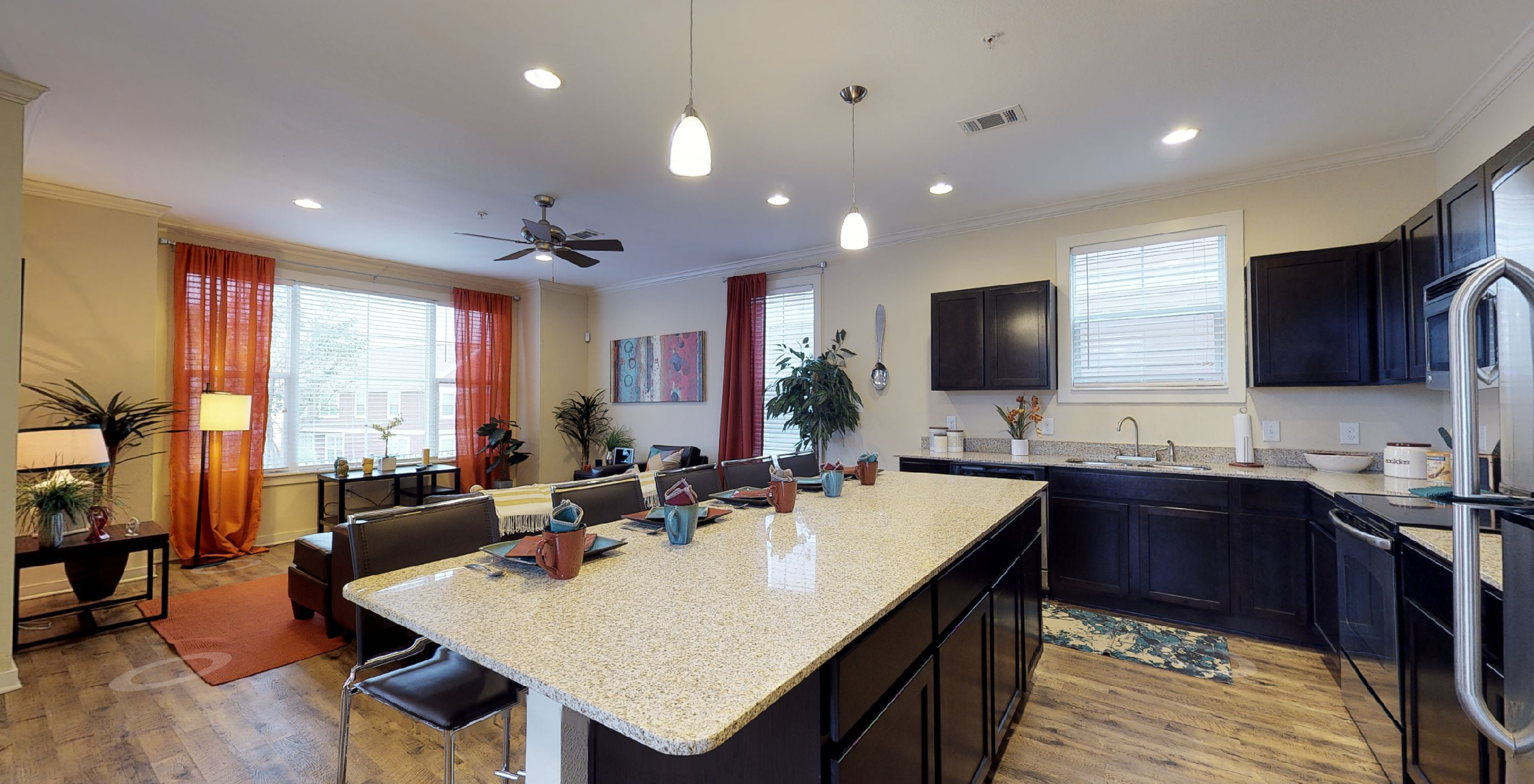 Kitchen with large island, granite counters, and stainless steel appliances